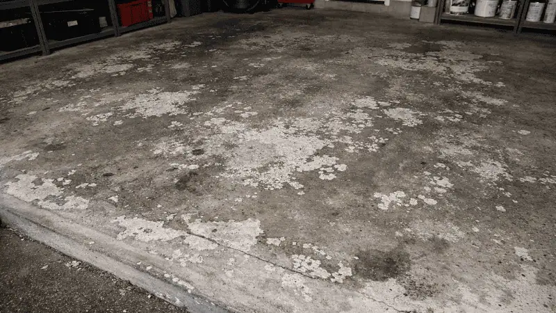 Garage concrete floor before coating with worn unfinished surface
